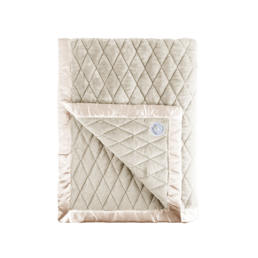 Quilted weighted blanket for babies with diamond pattern on a white background