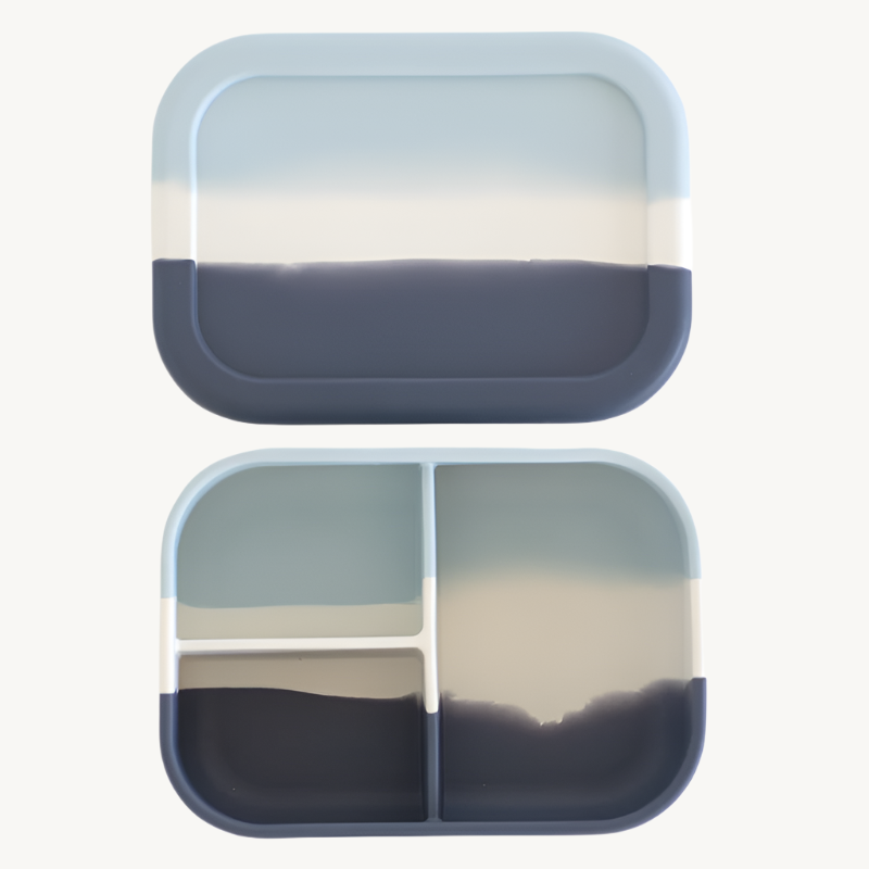 Two-tiered Bento compartmentalized container with gradient blue and beige design on a white background