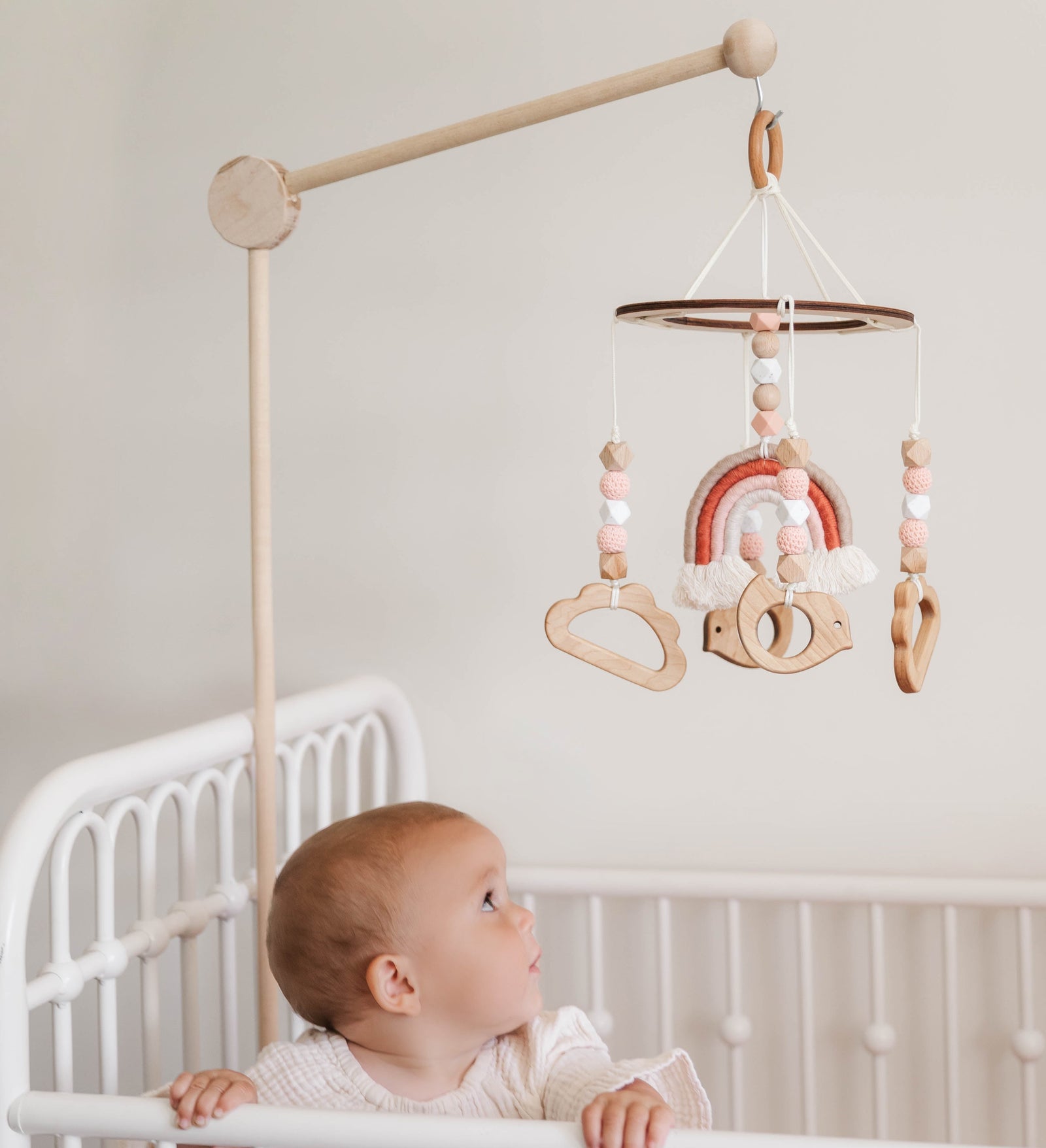 Baby looking at a mobile in a crib