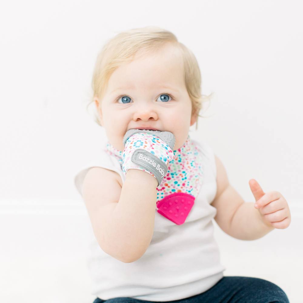 Bazzle Baby Chew Mitt in colorful watercolor dots.
