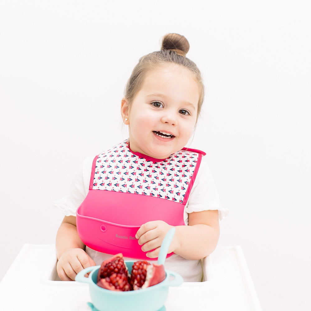 Bazzle Baby Foodie Silicone and Fabric Bib in pink and white triangles.
