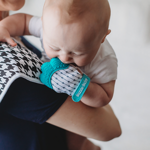 Teething glove in teal and white. BPA free and bacteria resistant silicone teething mitten.