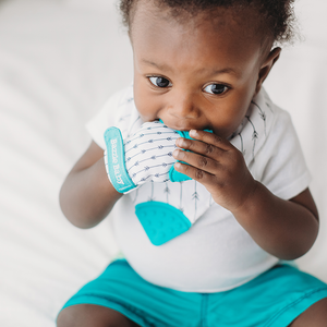 Teething glove in teal and white. BPA free and bacteria resistant silicone teething mitten.