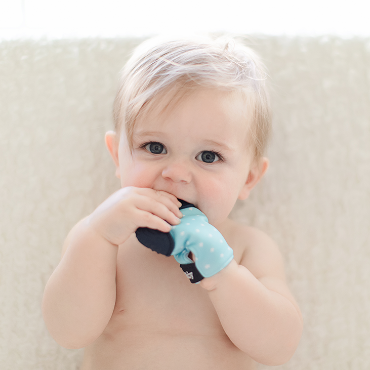 Teething glove in light blue and teal. BPA free and bacteria resistant silicone teething mitten.