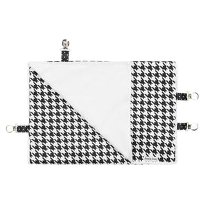 Black and white houndstooth Bazzlebaby GoBlanket. Features clips on the sides of the blanket to ensure it stays put on the car seat, stroller or clothing. Cotton front and fleece back.