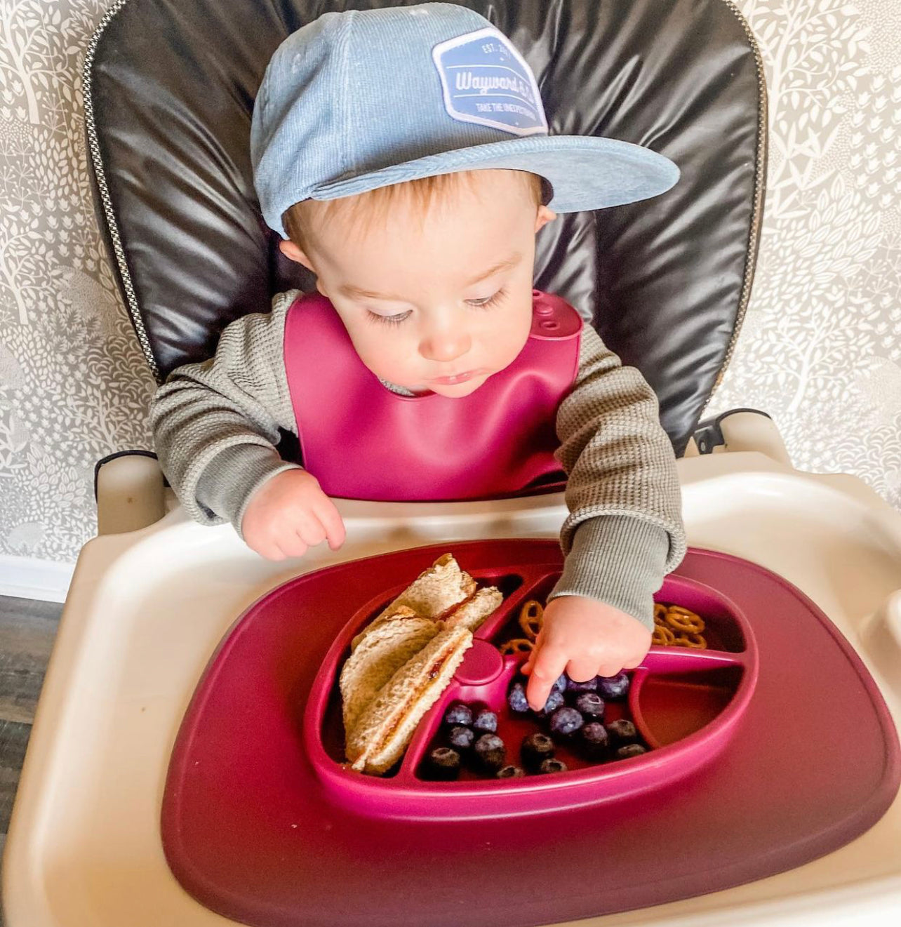 Bazzle Baby Anchor Silicone Mat in cranberry. Suctions to flat surfaces to not fall or slip.