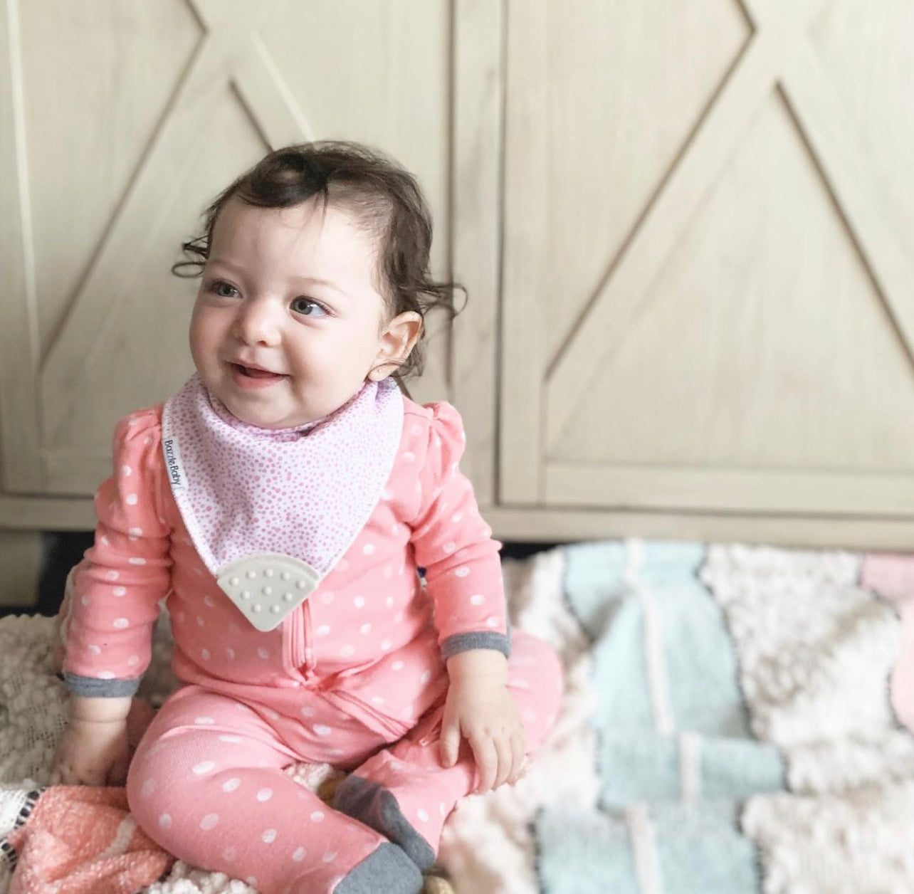 Baby wearing Bandana Drool Bib with Silicone Teether Attached
