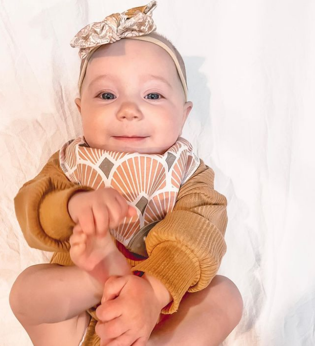 Baby wearing Bandana Drool Bib with Silicone Teether Attached