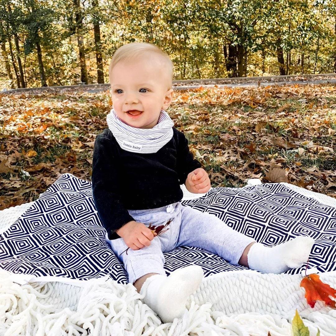 Baby infinity scarf drool bibs and a travel stroller blanket with clips.