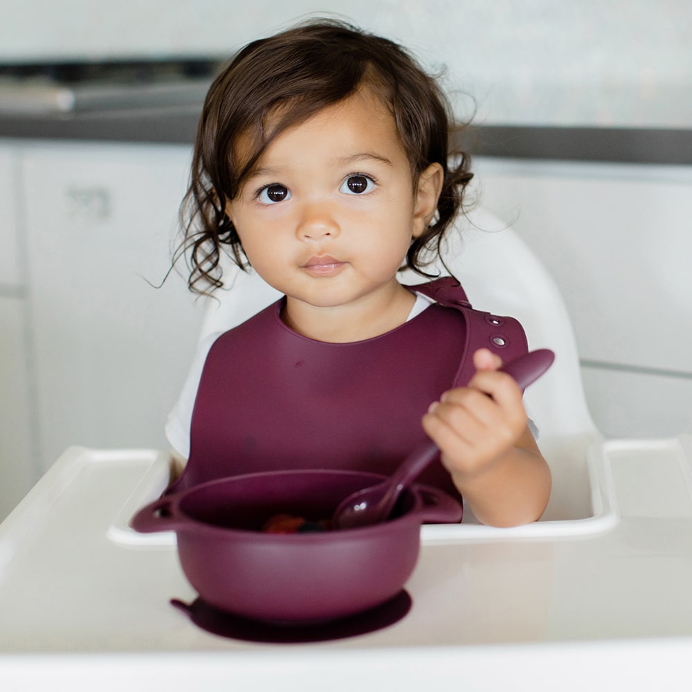 Bazzle Baby Anchor Silicone Plate in cranberry. Suctions to flat surfaces to not fall or slip.