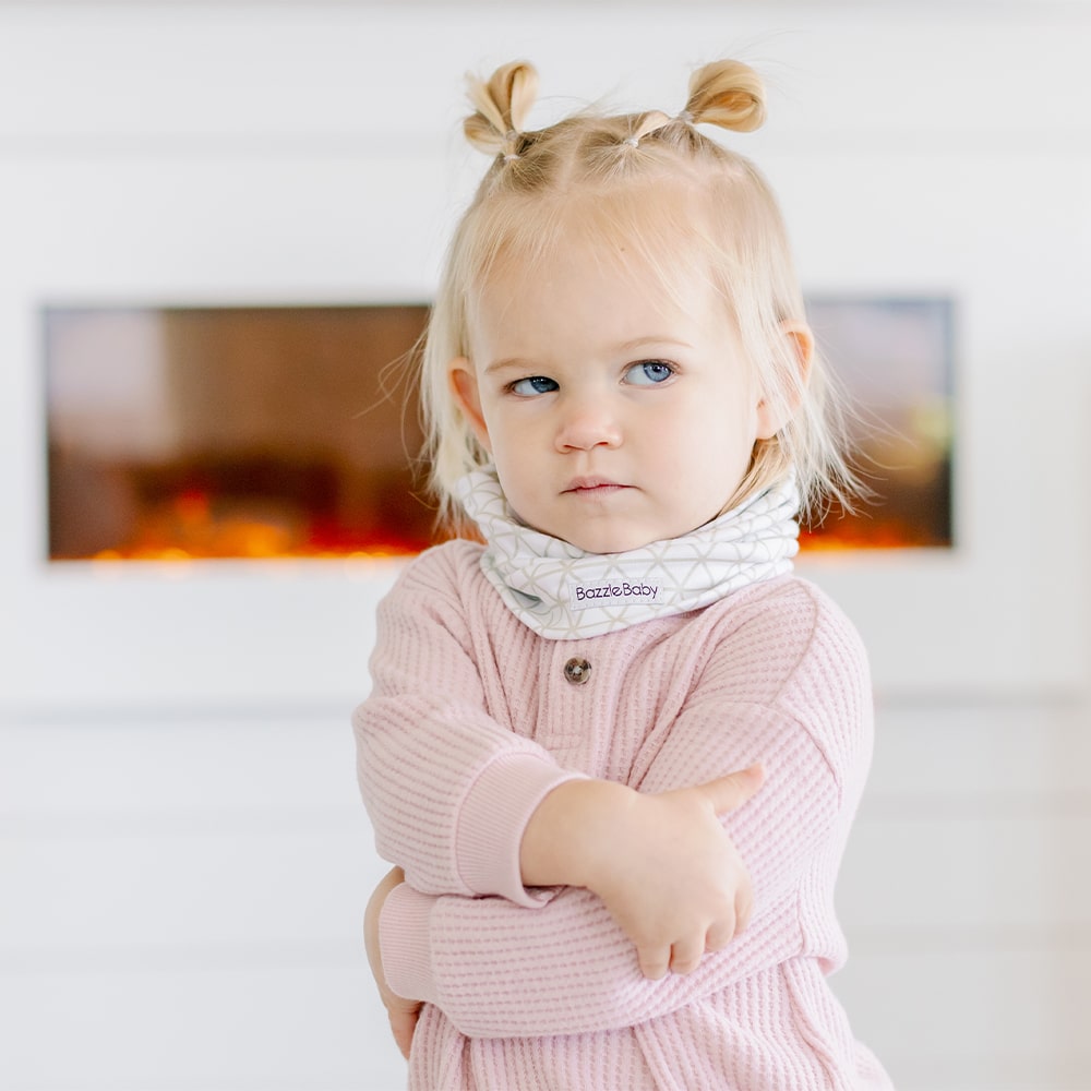 Baby wearing infinity scarf drool bib in white.