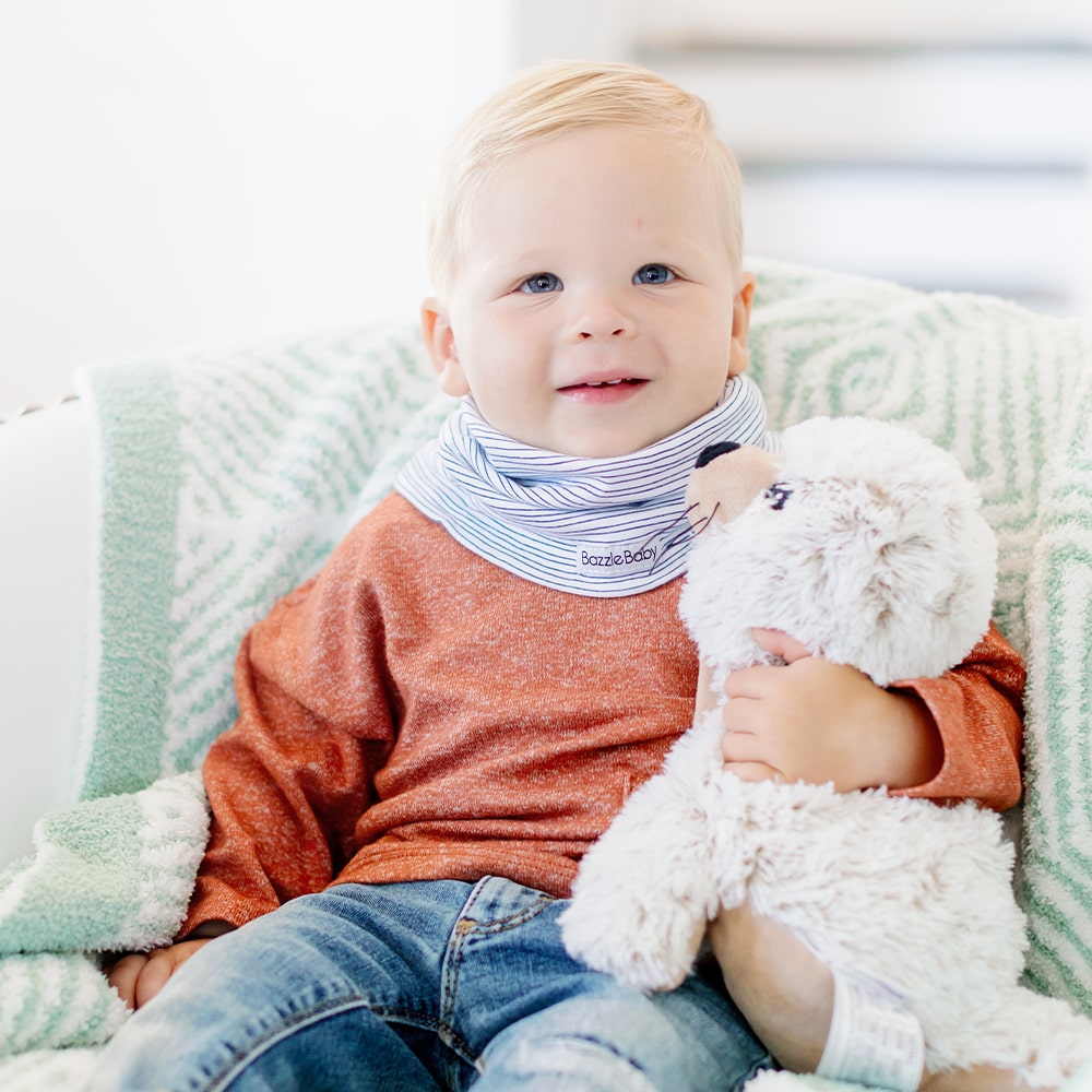 Baby wearing infinity scarf drool bib in black and white stripes.